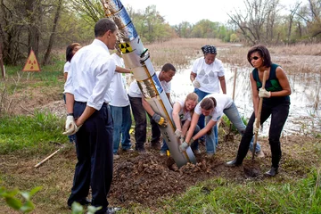 Przeróbka zdjęcia Baracka Obamy z żoną, nadzorujących sadzenie młodego drzewa 