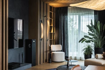 Projekt pracowni masz.design pokazuje, że ciemna kolorystyka, naturalne drewno i światło mogą stworzyć wnętrze pełne spokoju, elegancji i ponadczasowego charakteru 