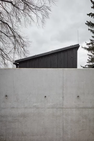 Przytulne wnętrza skryte za betonową ścianą, projekt Mjölk architekti Linka, Mjolk