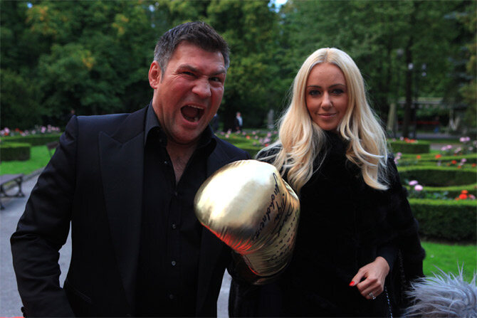 Były bokser Dariusz Michalczewski wraz z żoną prezentuję złotą rękawicę - prezent dla jubilata (fot. PAP/Piotr Wittman)