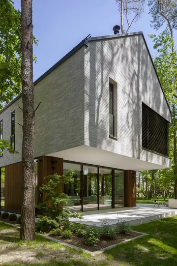 Dom Przenikający autorstwa Exterio Architektura to przykład nowoczesnej architektury, w której światło, natura i starannie zaprojektowana przestrzeń tworzą harmonijną całość 