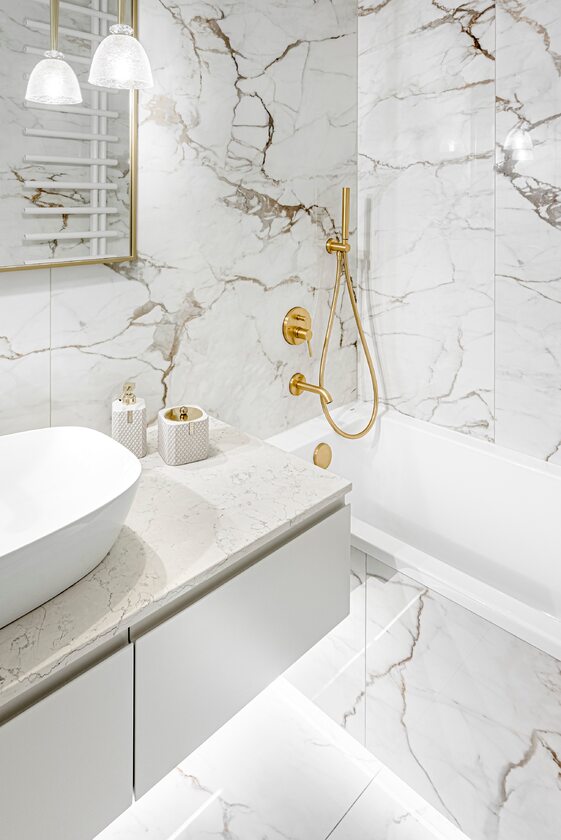 Łazienka wykończona marmurem ze złotymi dodatkami, projekt: Decoroom 