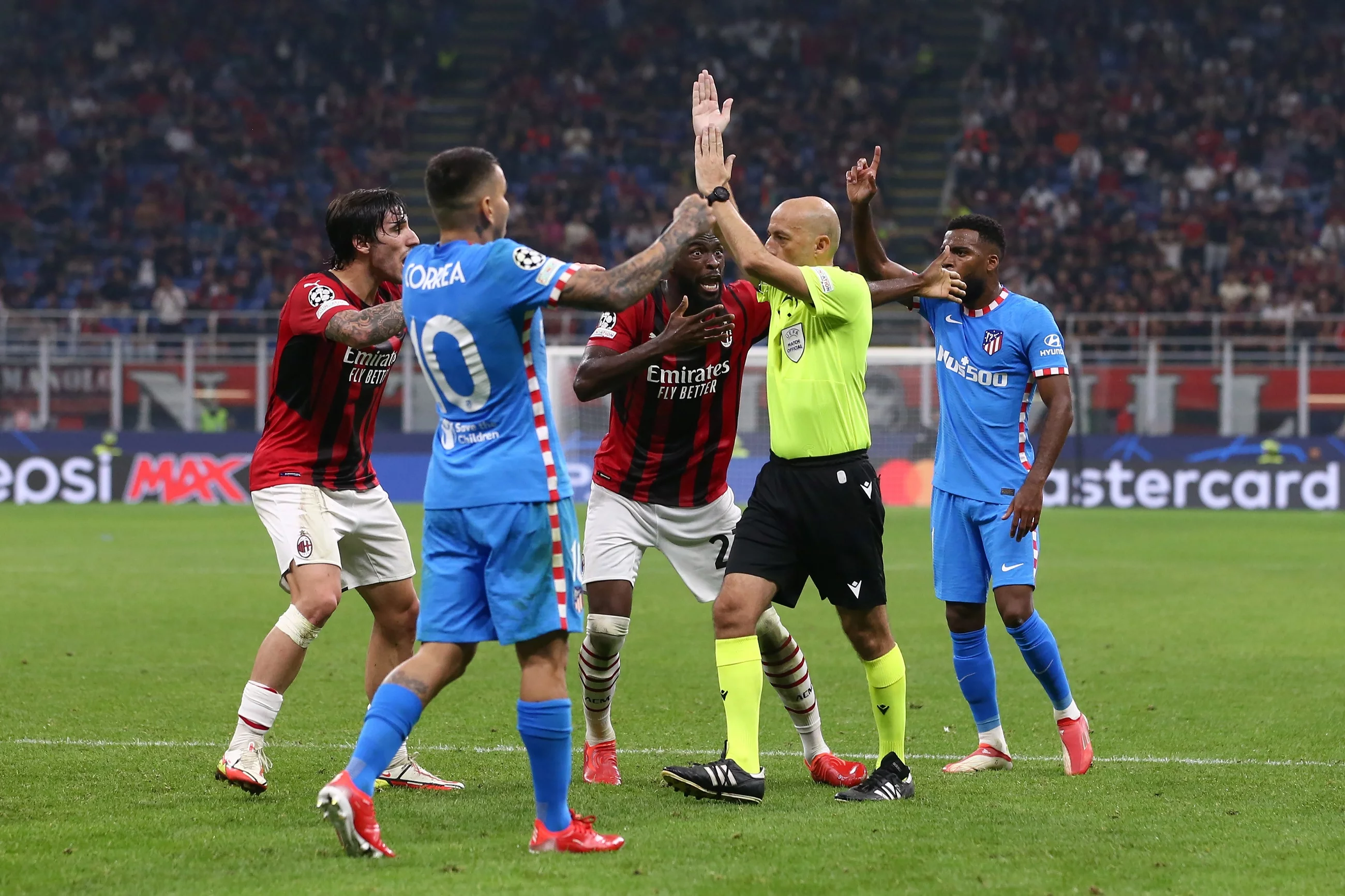 Cuneyt Cakir i piłkarze Milanu oraz Atletico