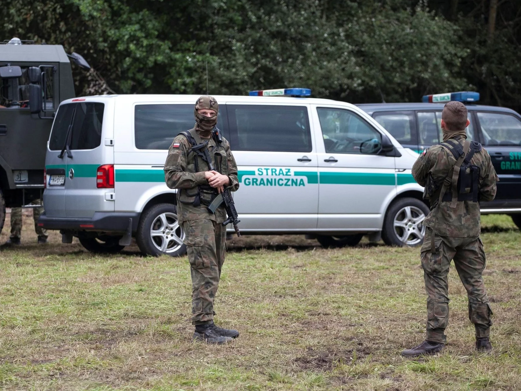 Strażnicy graniczni i żołnierze blokujący przejście migrantom na granicy polsko-białoruskiej