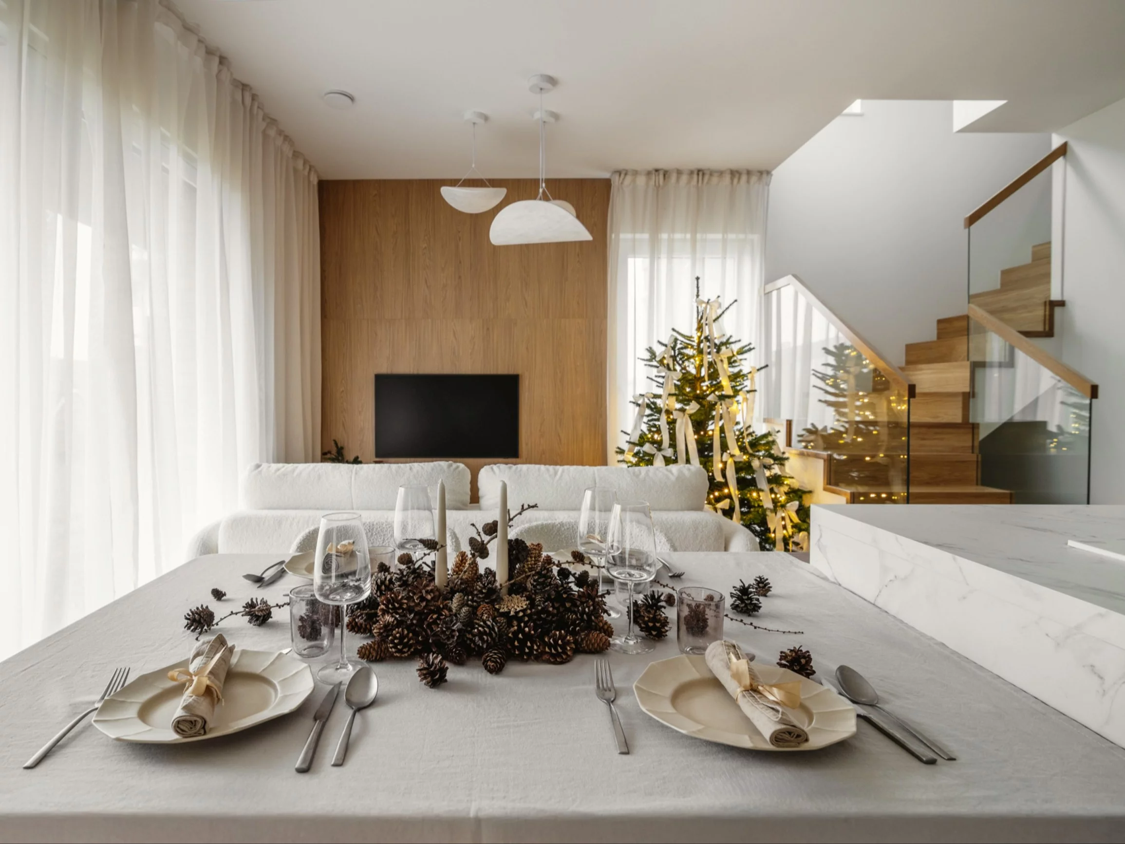 Świąteczna odsłona domu pokazowego Riva Park od Sainz Development, zaprojektowana przez Decoroom – subtelna kompozycja naturalnych dekoracji i neutralnych barw, która harmonijnie dopełnia ponadczasową estetykę wnętrza