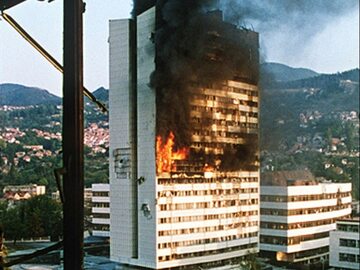 Jedno z najsłynniejszych zdjęć, dokumentujących wojnę w byłej Jugosławii. Przedstawia płonący budynek parlamentu w Sarajewie, trafiony pociskiem artyleryjskim.