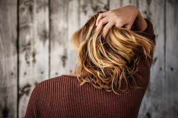 Kobieta przeczesująca placami włosy