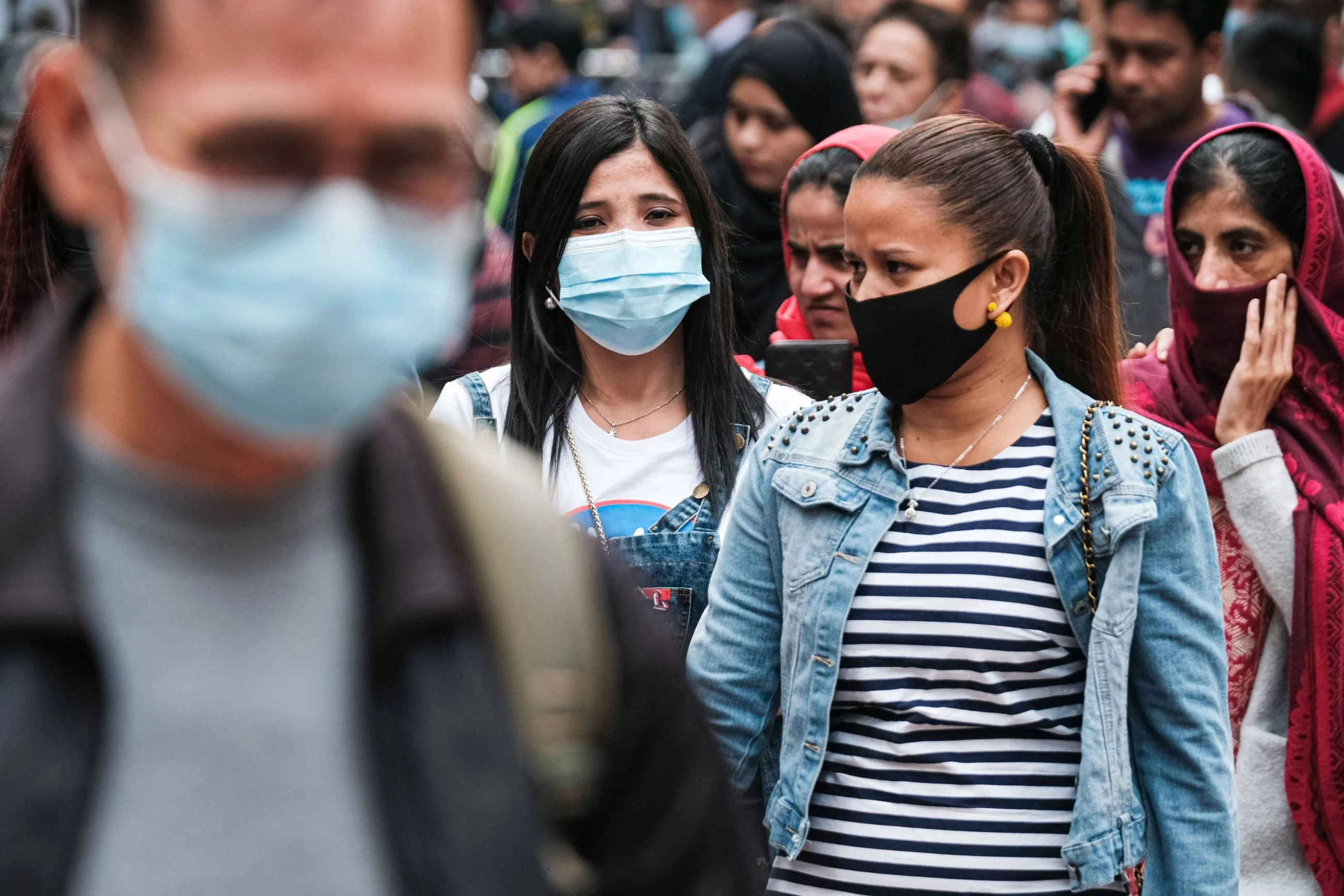 Przechodnie w maseczkach na ulicach Hongkongu