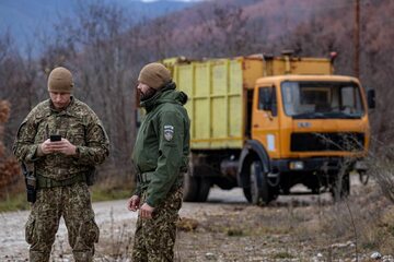 Łotewscy żołnierze służący w ramach misji NATO w Kosowie przeprowadzają inspekcję blokad drogowych ustawionych przez miejscowych Serbów w Mitrovicy