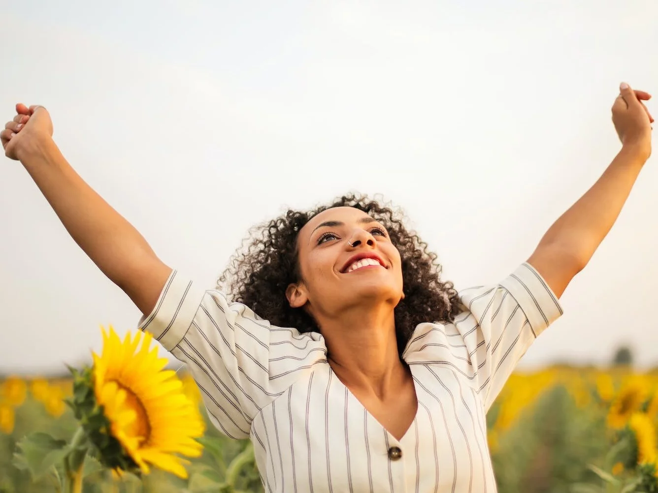 Photo Of Woman Standing On Sunflower Field