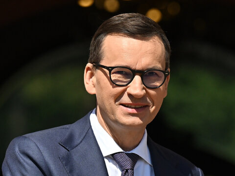 prompthunt: screenshot of a smiling muscular matusz morawiecki