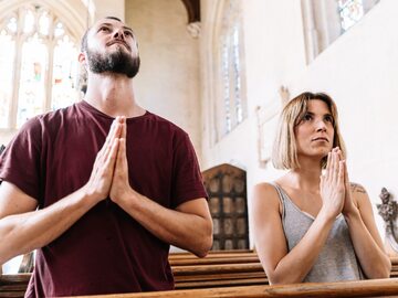 Para modląca się w kościele