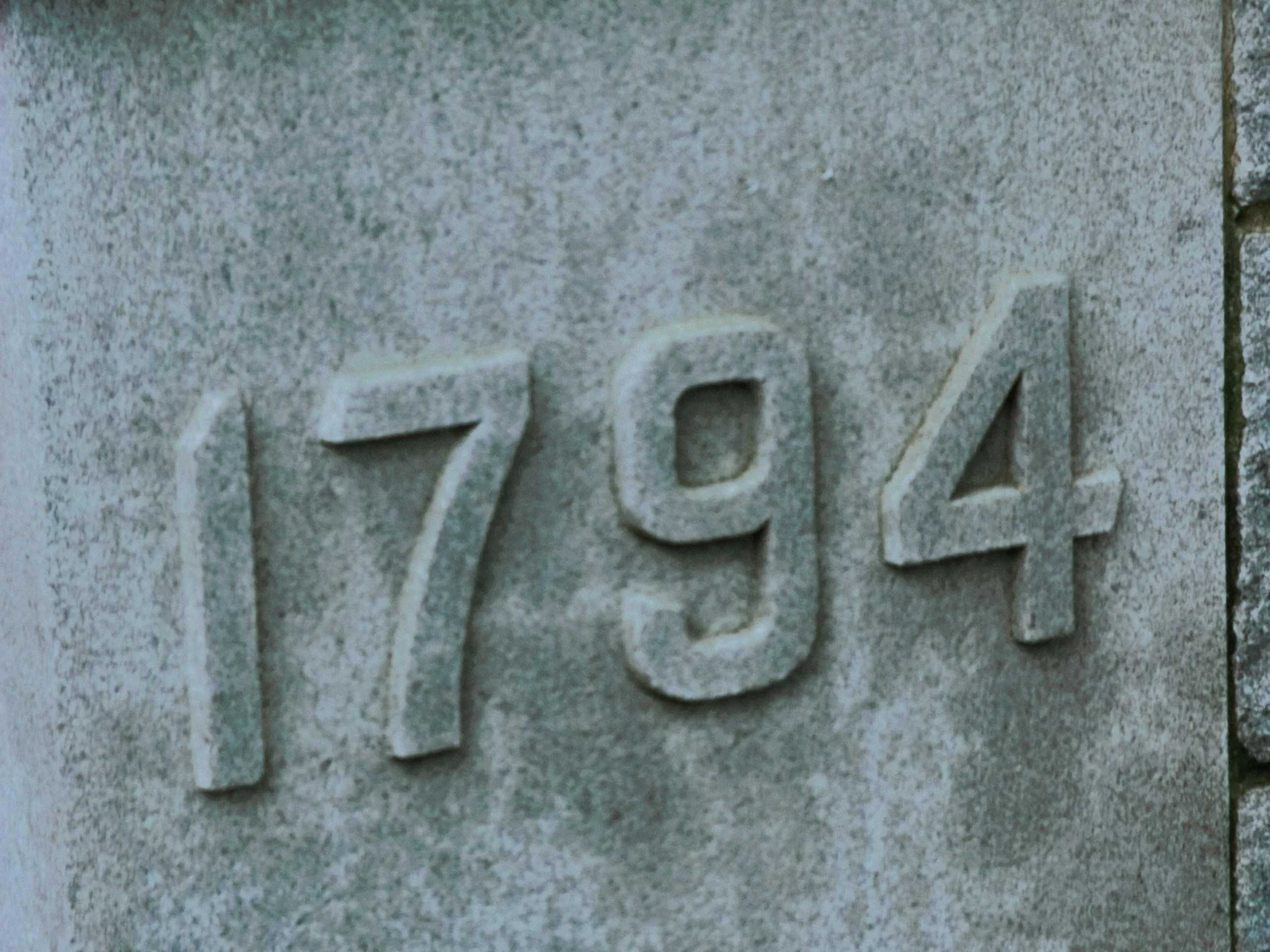 The number 1794 carved into a grey stone surface