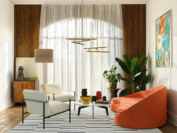 Sofa w kolorze terakoty i barwny obraz ożywiają niewielki pokój