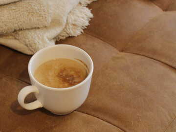 Stawianie kawy na sofie jest ryzykowne. Zwłaszcza kawy z mlekiem, które sprawia, że plamy są trudniejsze do usunięcia